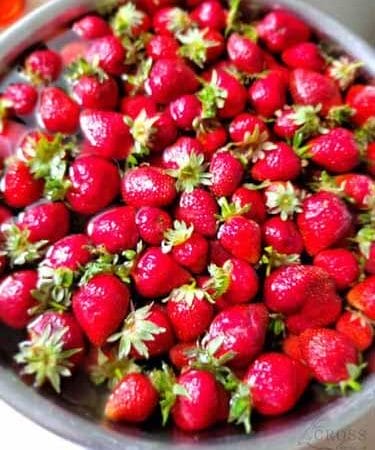 Beautiful glossy strawberries in a bowl all ready to eat