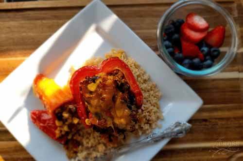 Mexican Quinoa Stuffed Pepper with a side of blueberries and strawberries.