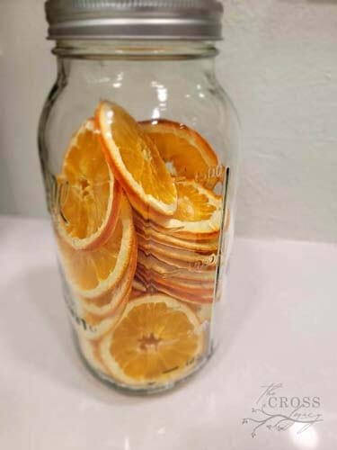 Mason jar filled with dried orange slices.