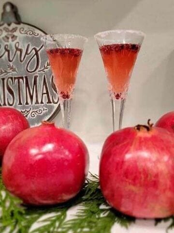 delicious pomegranate mimosas with fresh pomegranate juice, a fresh orange peel for garnish, and a mix of amazing syrups from Simple Goodness Sisters