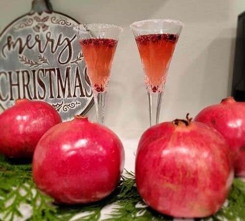 delicious pomegranate mimosas with fresh pomegranate juice, a fresh orange peel for garnish, and a mix of amazing syrups from Simple Goodness Sisters