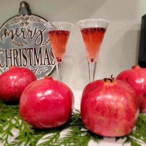 delicious pomegranate mimosas with fresh pomegranate juice, a fresh orange peel for garnish, and a mix of amazing syrups from Simple Goodness Sisters