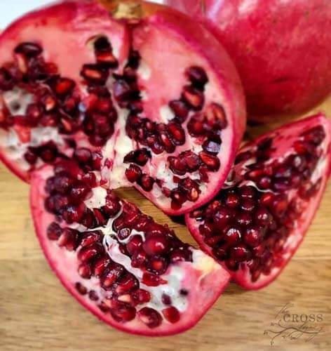 pomegranate-cut-open-sitting-on-a-cutting-board