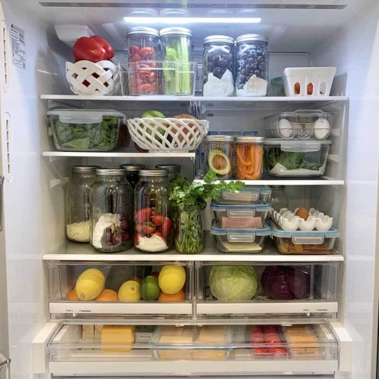 Inside look of Amy's refrigerator showing her salad basket and produce in her crisper drawers.