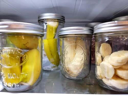 bananas-in-mason-jars-in-the-fridge-some-are-peeled-and-sliced-cut-in-half-others-are-not-peeled-and-cut-in-half-and-in-quarters