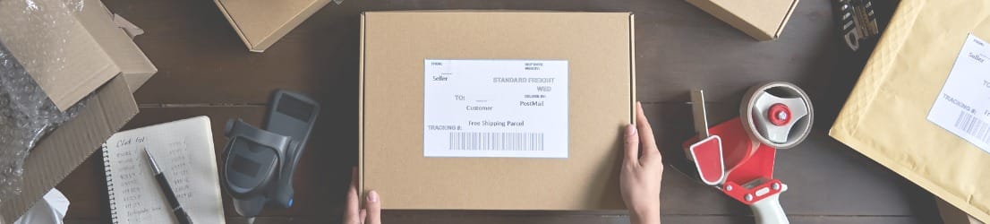 table-top-with-packages-bubble-wrap-tape-gun-and-shipping-supplies