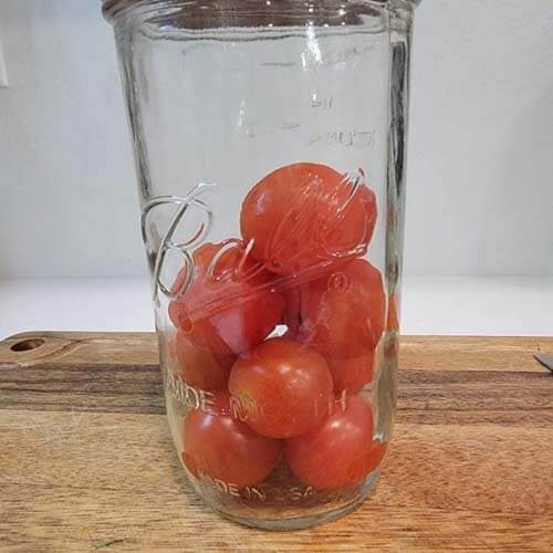 jar with cherry tomatoes ready to add to a salad