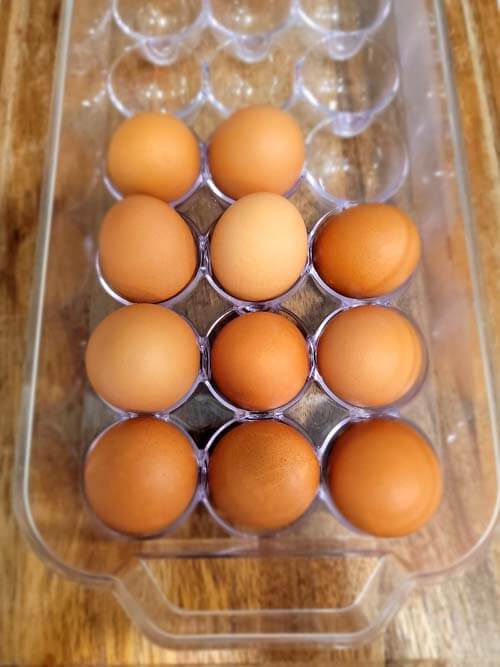 hard boiled eggs inside acrylic container ready to slice up and add to salads