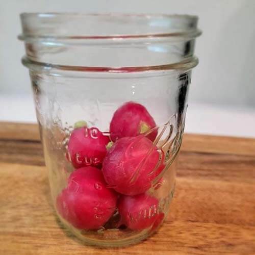 jar with some radishes ready to chop up and add to a salad