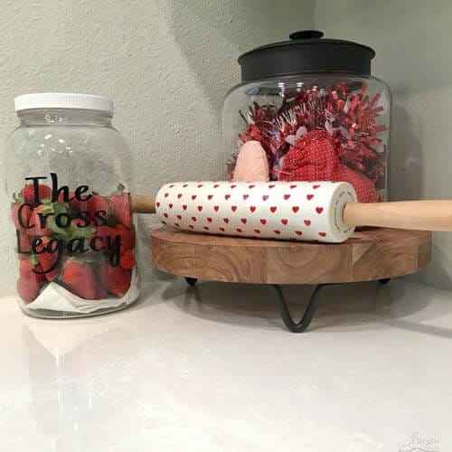 strawberries in a jar next to Valentines Day themed kitchen items on counter