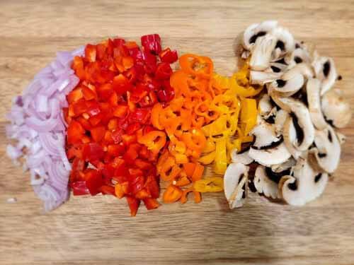 chopped onions, peppers, and mushrooms for pizza toppings