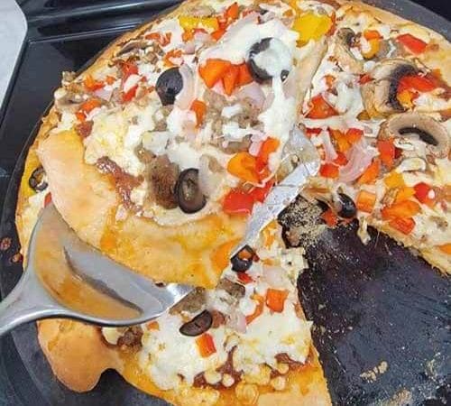 delicious homemade gluten-free pizza with a slice taken out of it