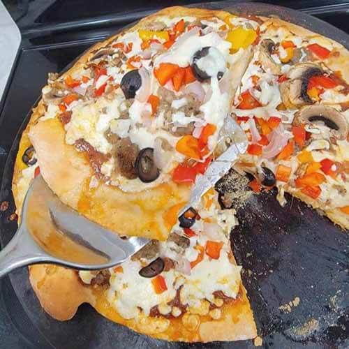 delicious homemade gluten-free pizza with a slice taken out of it