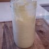 close-up-of-homemade-mayonnaise-in-a-glass-jar-sitting-on-a-cutting-board
