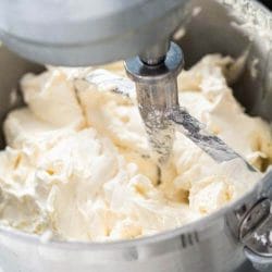 Close up of whipped icing in a Kitchen Aid mixer.