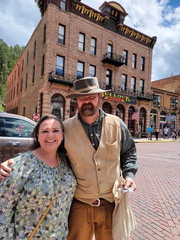 amy-cross-posing-with-a-cowboy-actor-at-Deadwood-experiencing-road-trip-adventures
