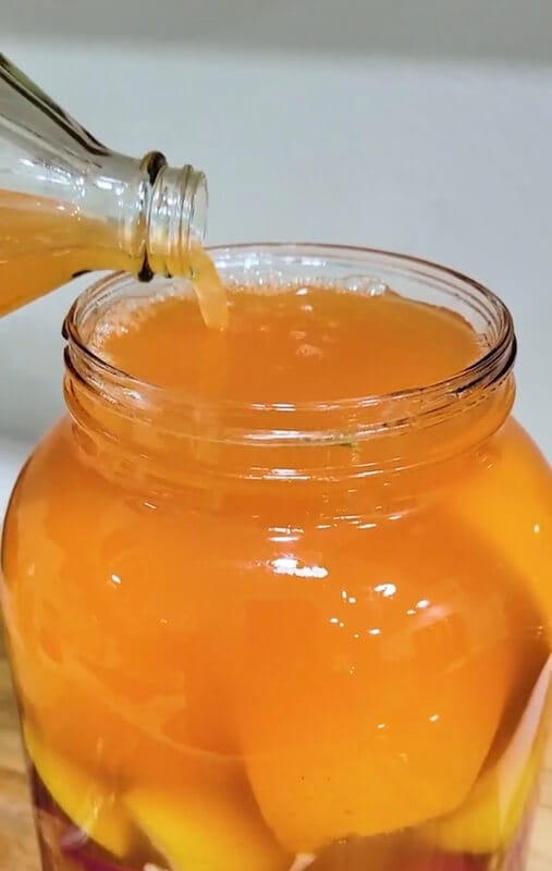 Pouring Apple Cider Vinegar into gallon jar