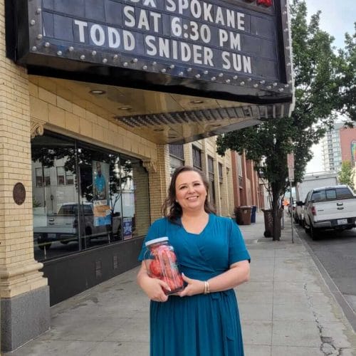 Amy standing outside the Bing Crospy Theater after her TEDx Talk holding a Strawberries in a Jar
