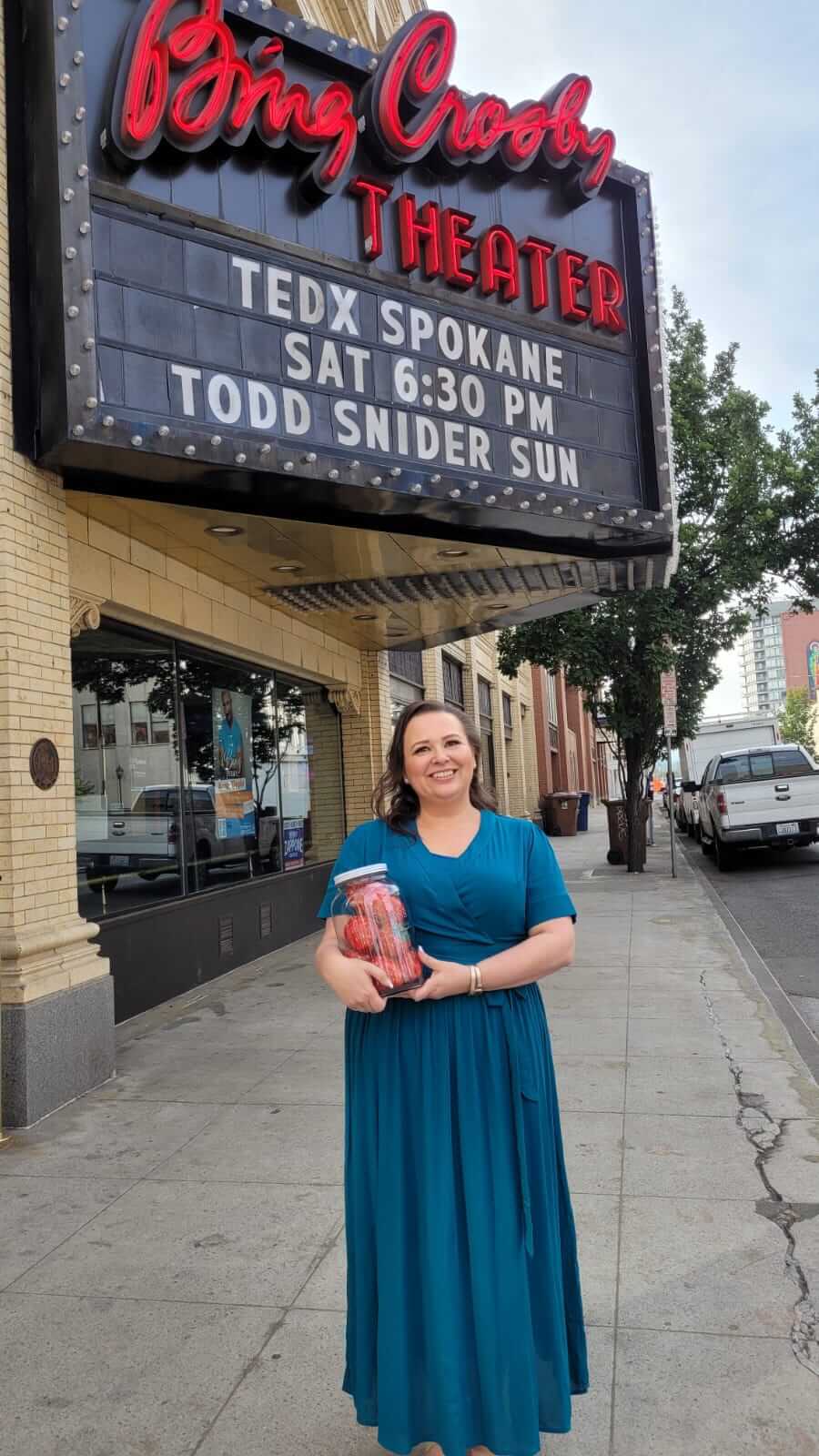 Amy standing outside the Bing Crospy Theater after her TEDx Talk holding a Strawberries in a Jar