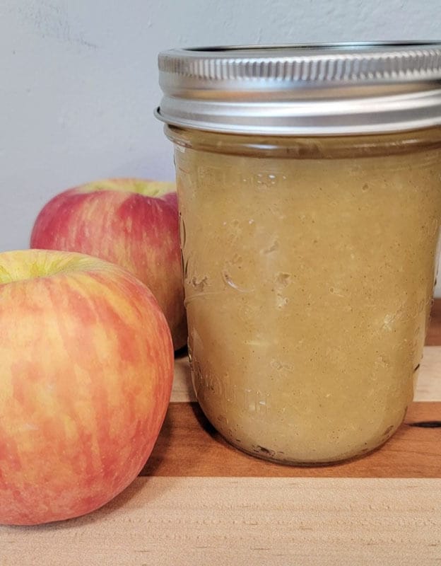 Easy Applesauce Recipe - Finished applesauce in jar with fresh apples