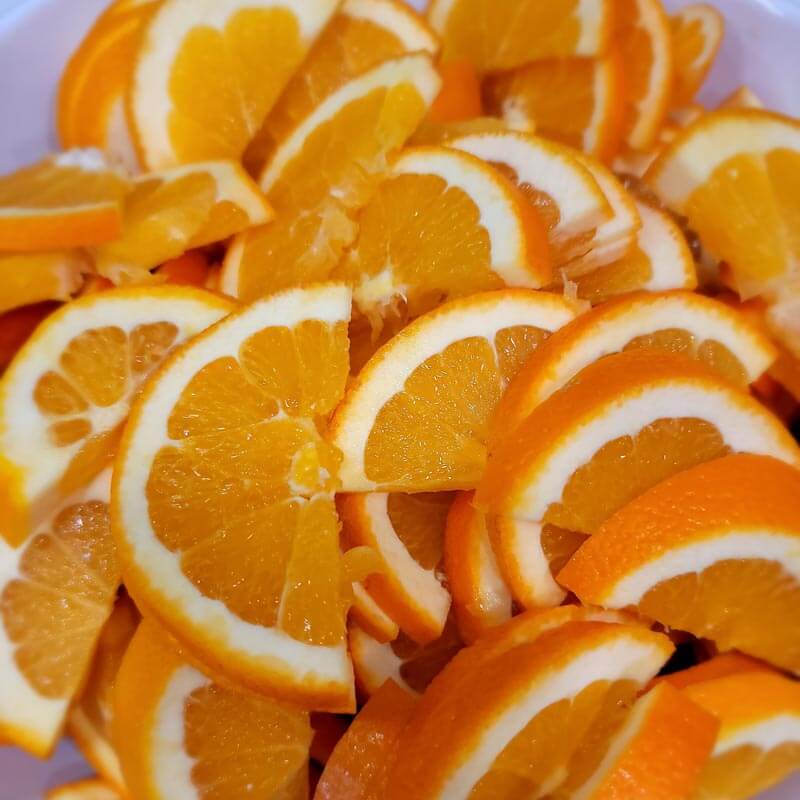 Fresh Cut Orange Slices in white bowl