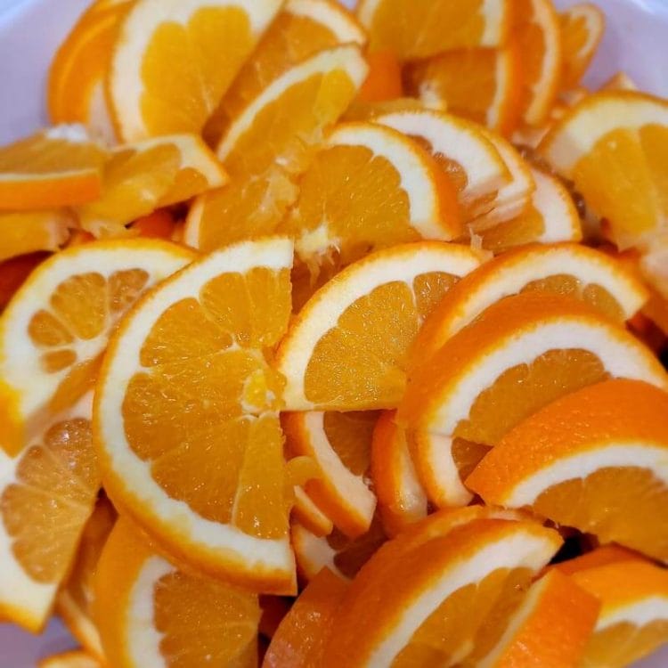 Fresh Cut Orange Slices in white bowl