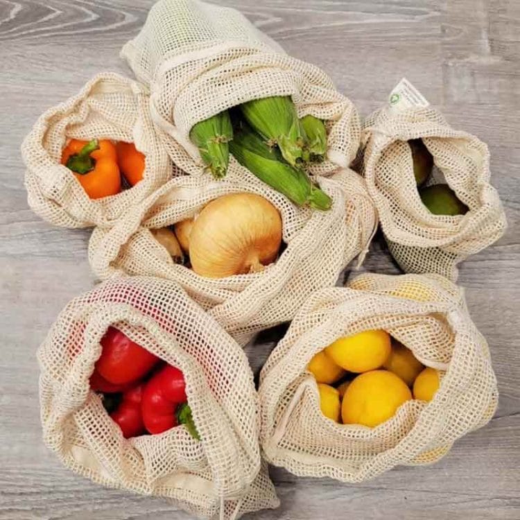 Red and Orange Bell Peppers, Corn on the Cob, Lemons and Limes in mesh produce bags from the Cross Legacy.