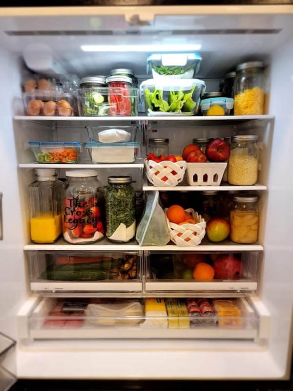 Fresh fruit and vegetables stored in glass in the refrigerator.
