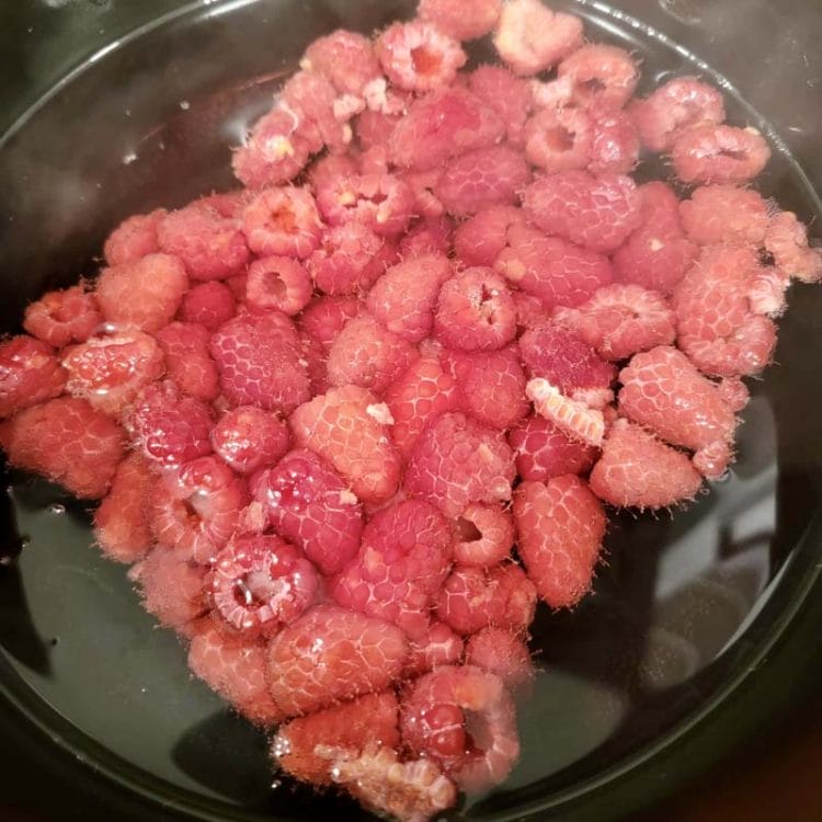 Raspberries in a pot of water which will be the Lavender egg dye color.