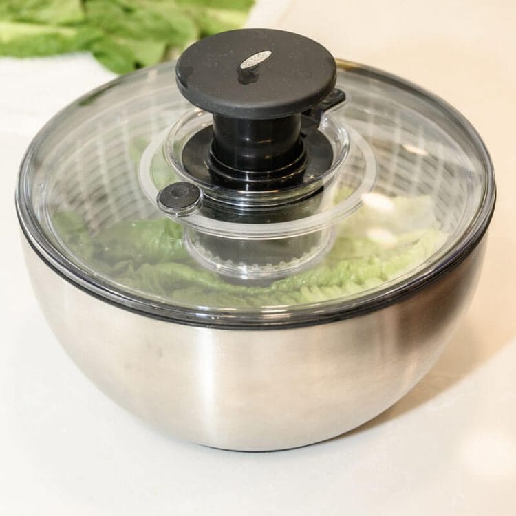 OXO Stainless Steel Salad Spinner with romaine lettuce inside.