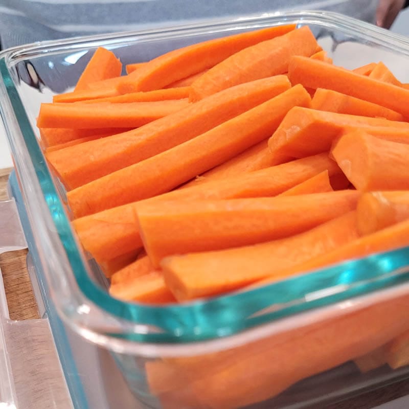 Store carrots in glass after being freshly washed, peeled, and cut into sticks.