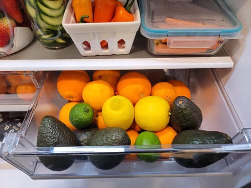 Avocados, lemons, limes, and oranges in the refrigerator crisper drawer to slow the ripening process.