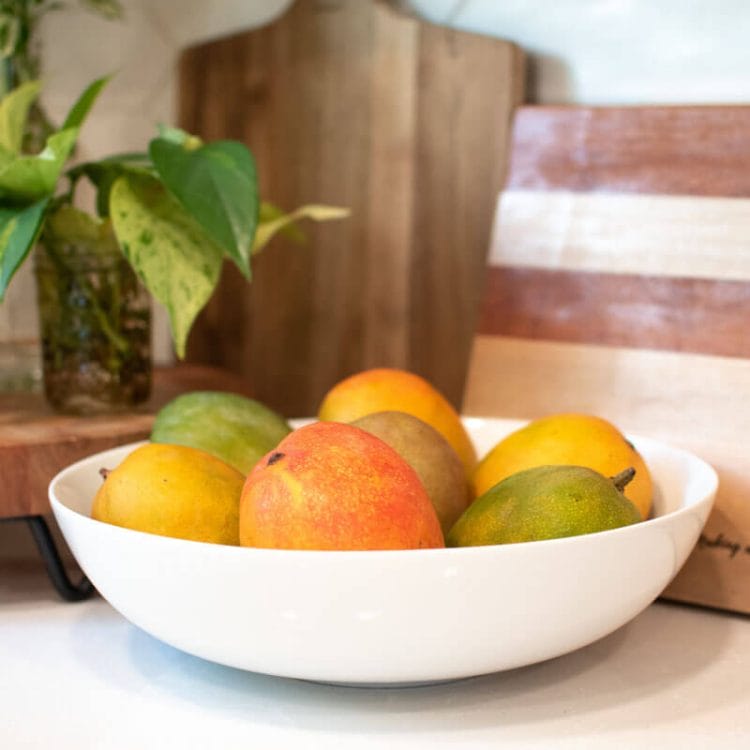 Summer Fruit, Mangos, in a white bowl on the counter.