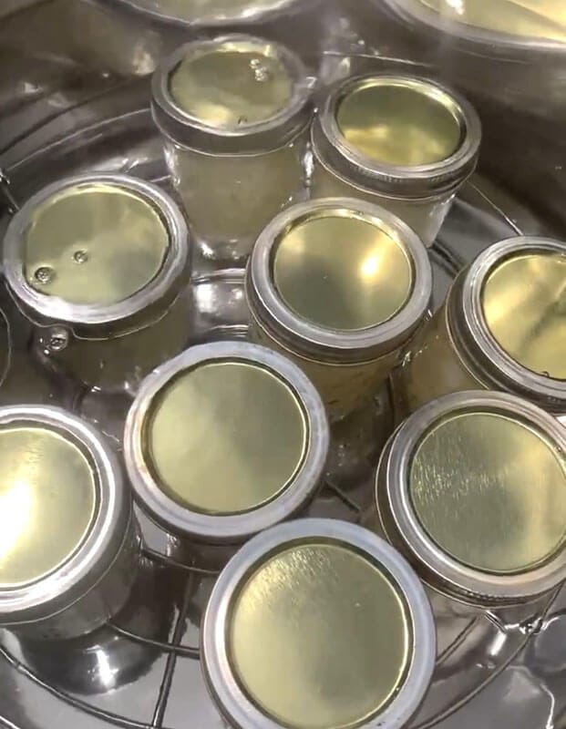9 jars of canning pears in a water bath canner.