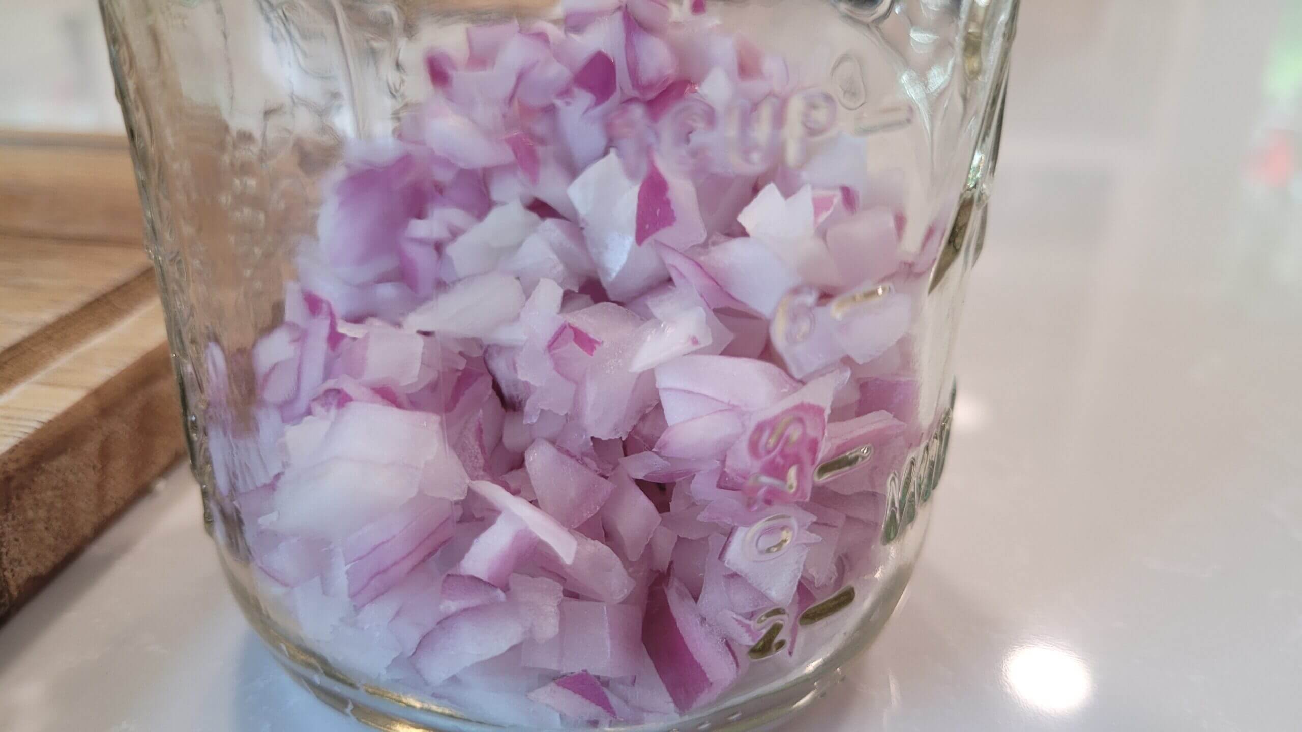 chopped onions in a glass jar 