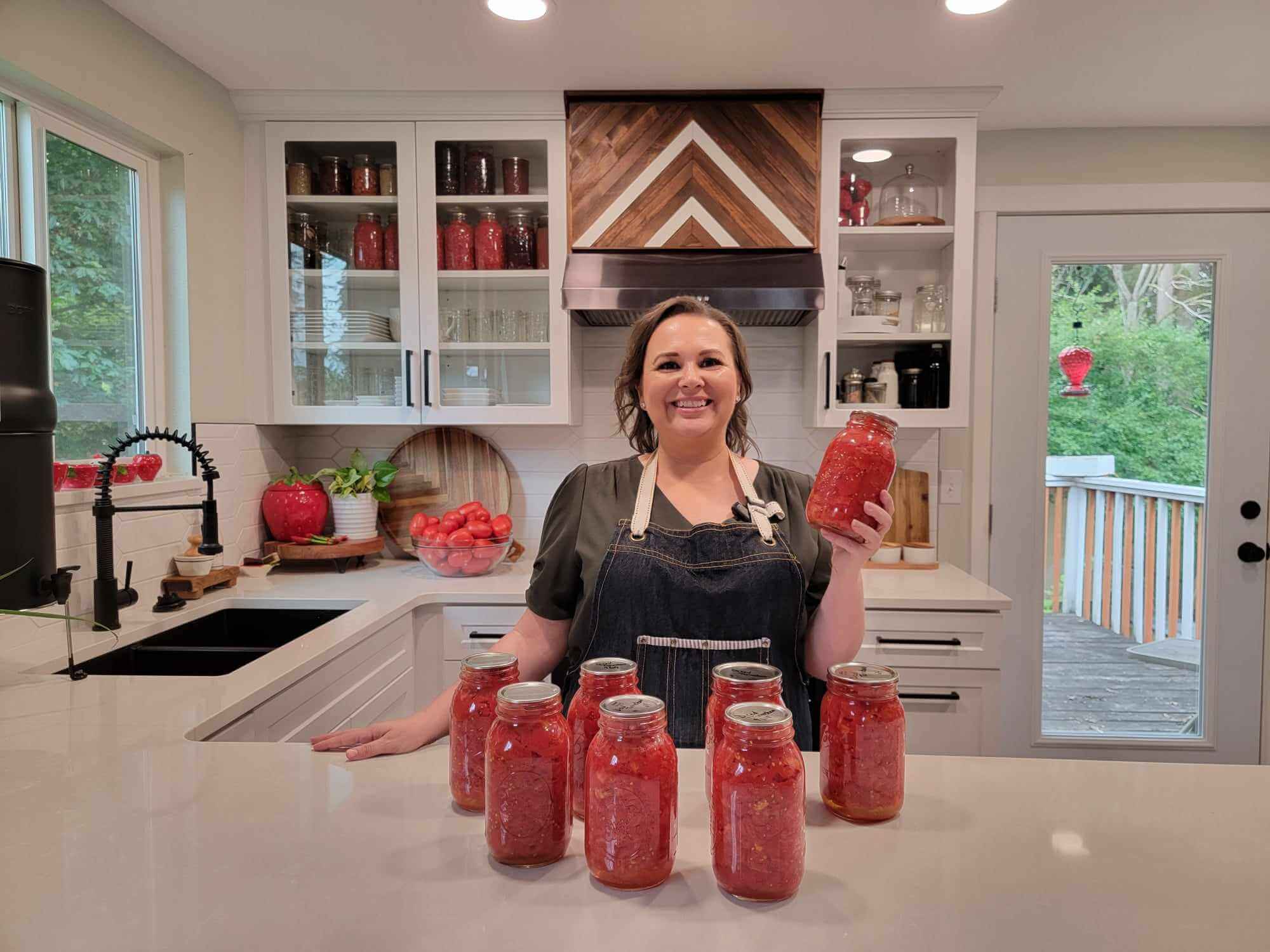 Amy with canned tomatoes on the counter
