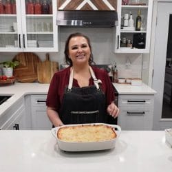 Amy with a cooked pan of lasagna on the counter