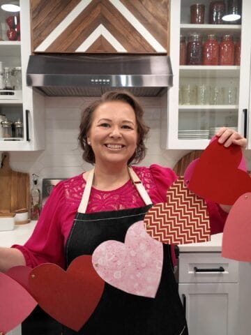 Amy in kitchen with paper heart garland